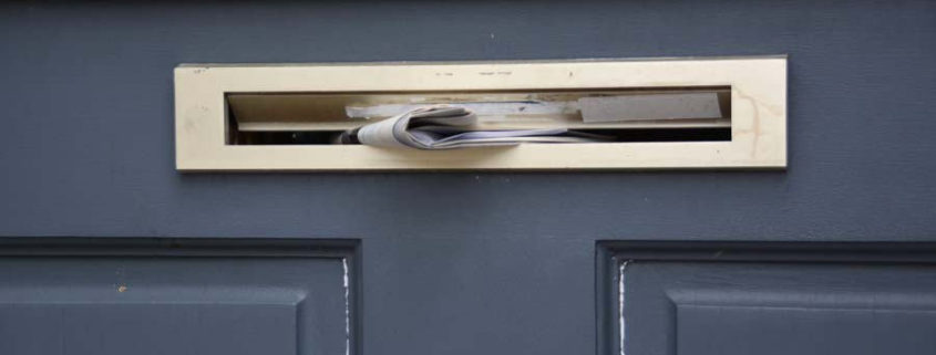 Flyer being pushed through a letterbox